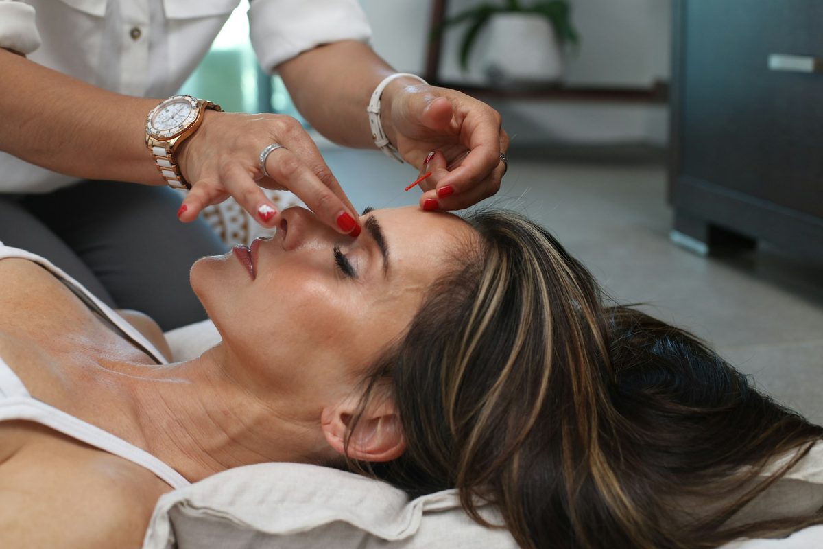 A clinician administering an injectable treatment to a client's face